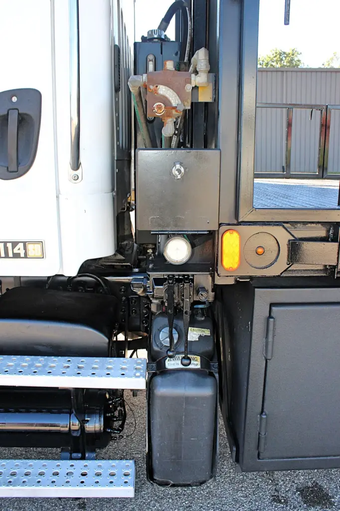 2018 Freightliner 114SD – hydraulic equipment and crane controls mounted behind the cab.