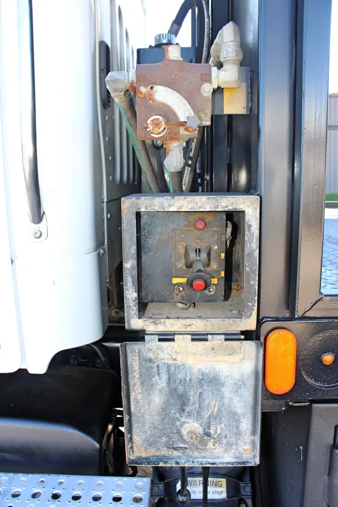 2018 Freightliner 114SD – close-up of hydraulic crane control station and equipment mounted behind cab.