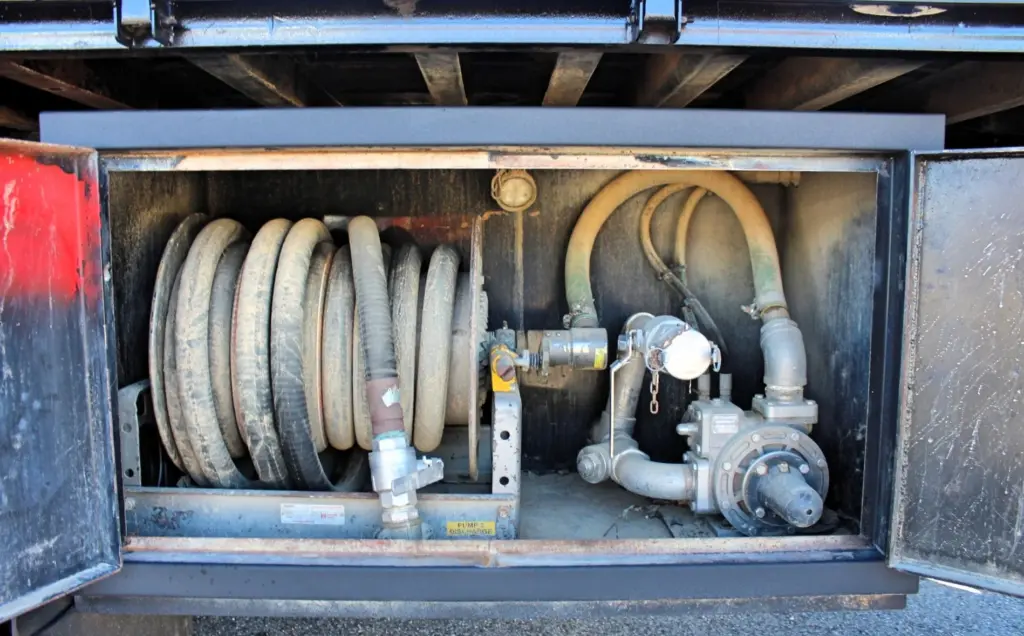 2018 Freightliner 114SD – equipment storage compartment with hose reel, pump and quick-connect fittings.