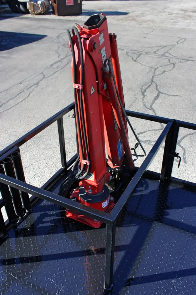 2018 Freightliner 114SD – elevated view of folded hydraulic crane and mounting area on flatbed body.