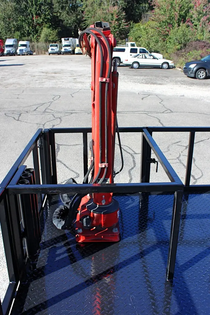 2018 Freightliner 114SD – rear-facing view of folded knuckle boom crane and hydraulic hoses.