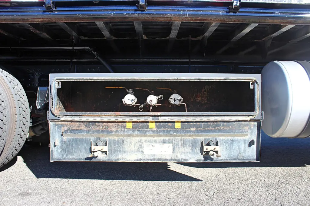 2018 Freightliner 114SD – underbody utility compartment with three fluid connection fittings.