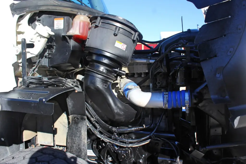 2018 Freightliner 114SD – engine bay showing air intake system, piping and engine components.