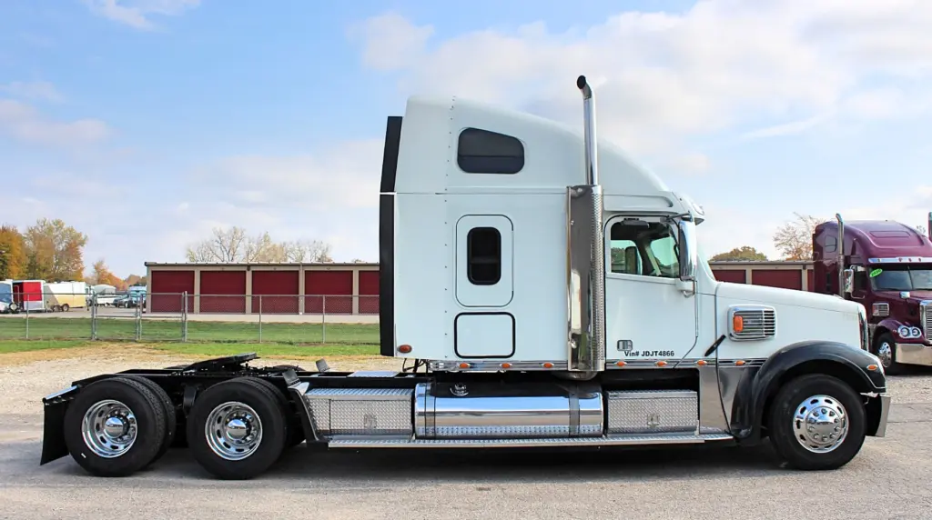 2018 Freightliner Coronado 132 — side profile of white sleeper tractor with chrome stack and aluminum wheels