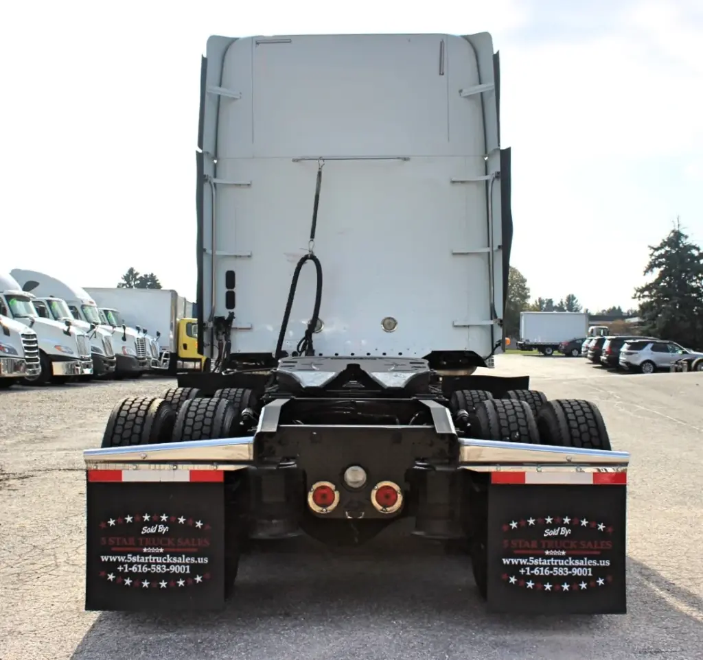 2018 Freightliner Coronado 132 — straight-on rear view of white sleeper cab with twin tail lights and dual tandem wheels.