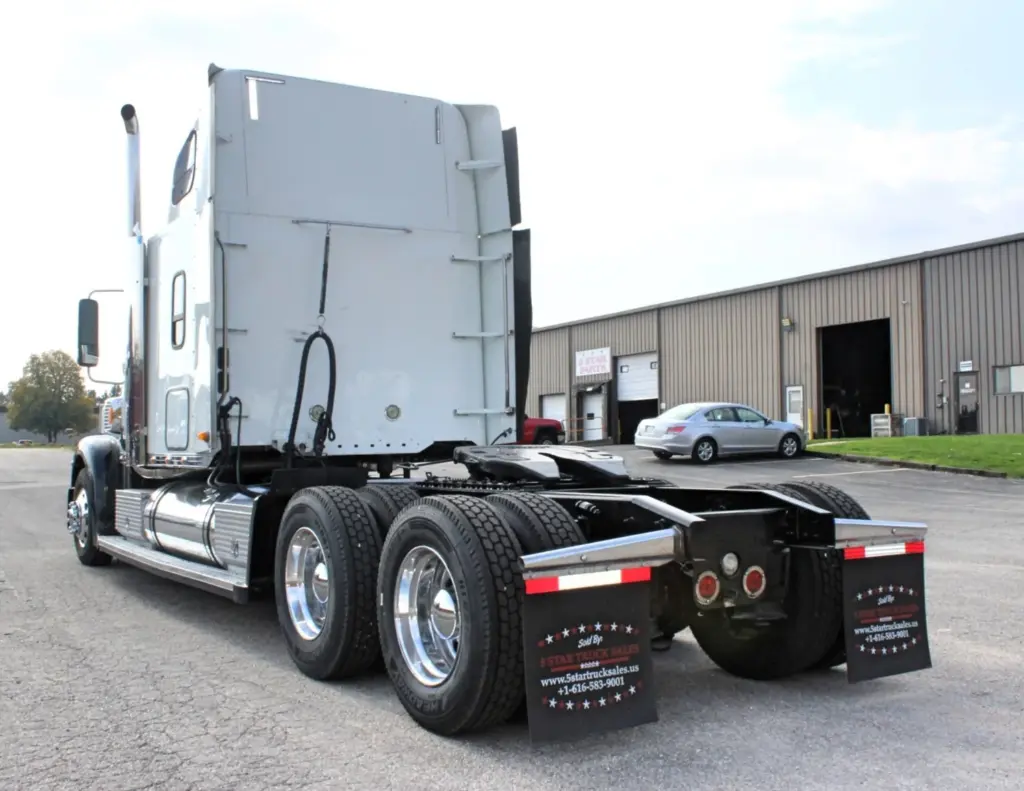 2018 Freightliner Coronado 132 — rear three-quarter view of silver sleeper tractor on tandem axles with mud flaps