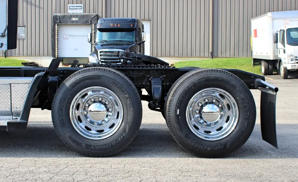 2018 Freightliner Coronado 132 — close side view of tandem drive axles with polished wheels and steel frame rail