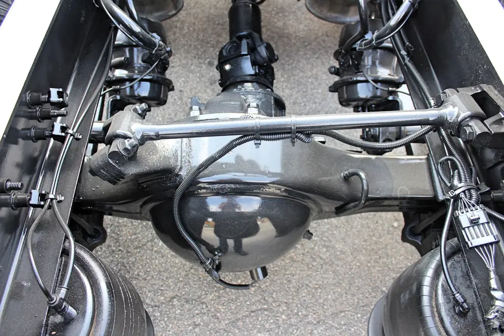 2018 Freightliner Coronado 132 — overhead view of black rear differential with driveshaft, air bags and brake chambers