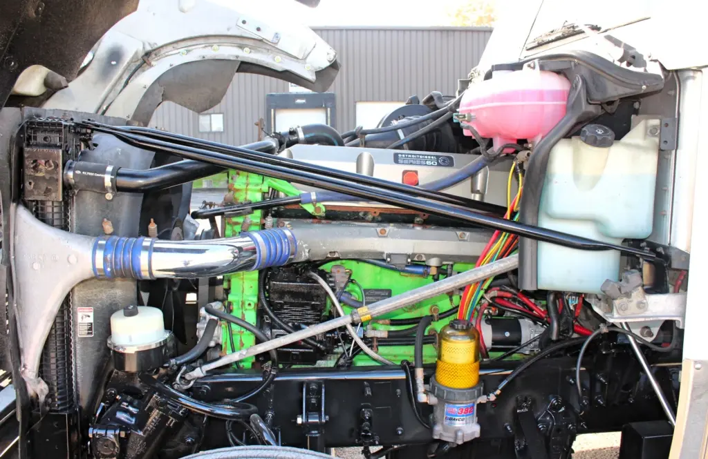 2018 Freightliner Coronado 132 — close look at green Series 60 engine with chrome intake tube and pink coolant tank