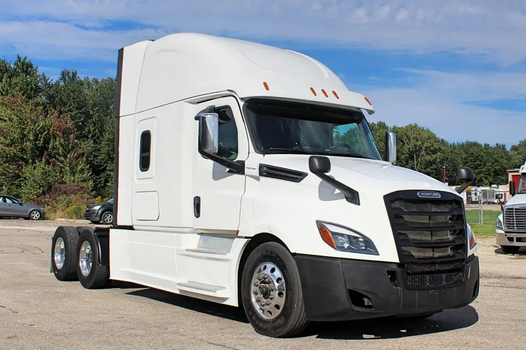 2019 Freightliner Cascadia 126 – white sleeper semi truck front three-quarter exterior view.