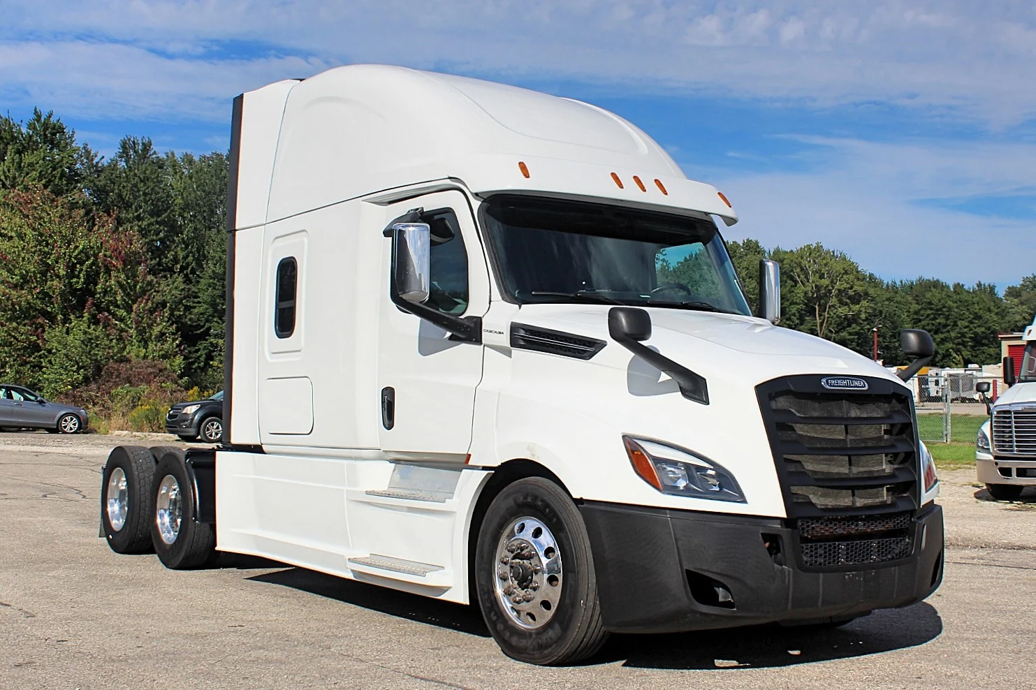 2019 Freightliner Cascadia 126 – white sleeper semi truck front three-quarter exterior view.