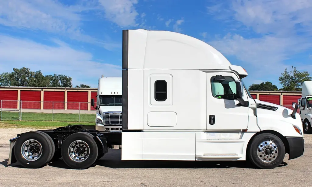 2019 Freightliner Cascadia 126 – passenger-side profile of white sleeper semi truck.