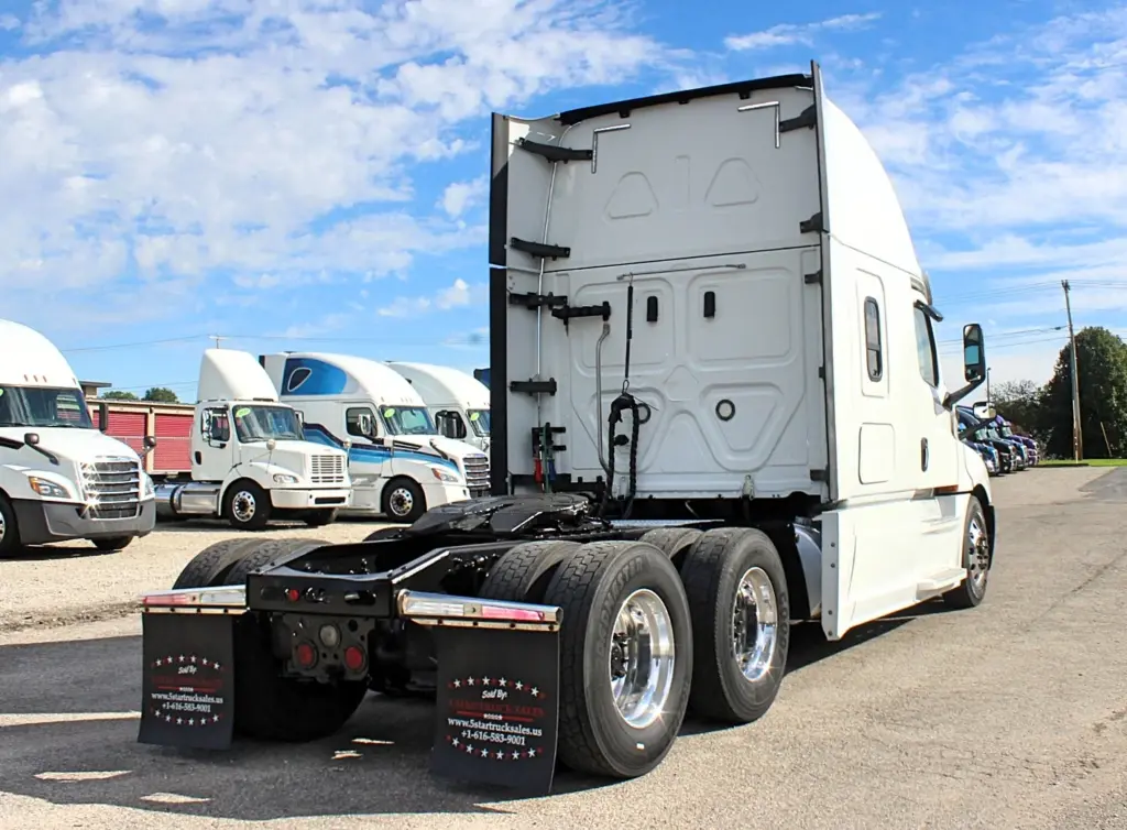 2019 Freightliner Cascadia 126 – rear three-quarter view of sleeper tractor and tandem axles.