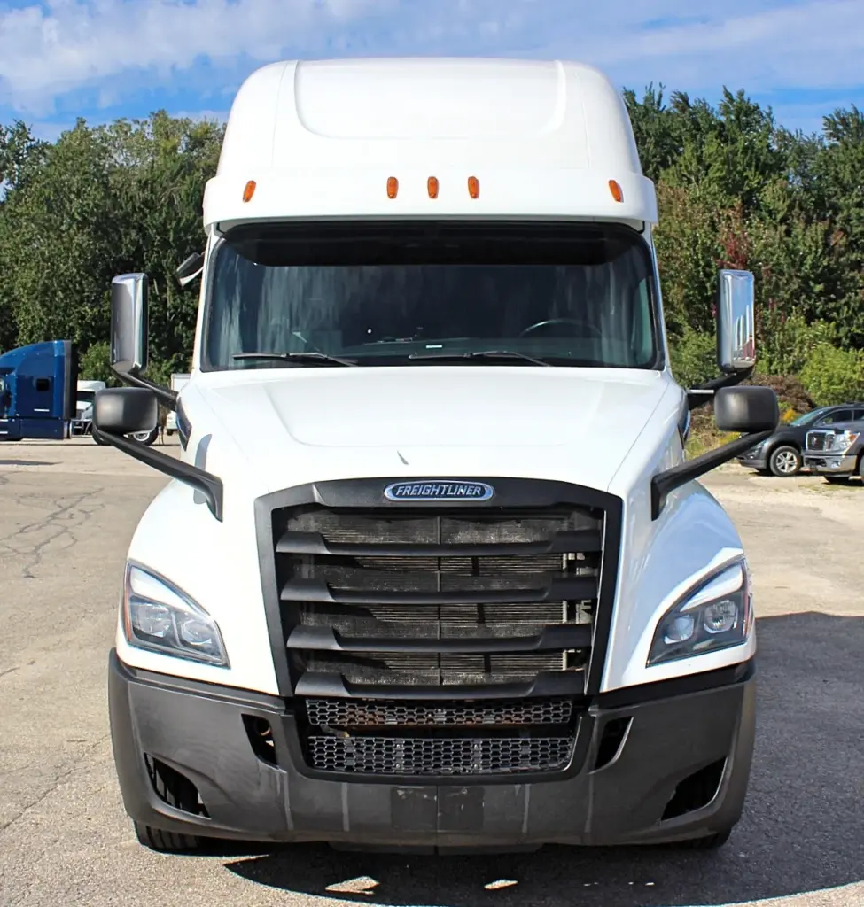 2019 Freightliner Cascadia 126 – straight front view of white Cascadia sleeper truck.