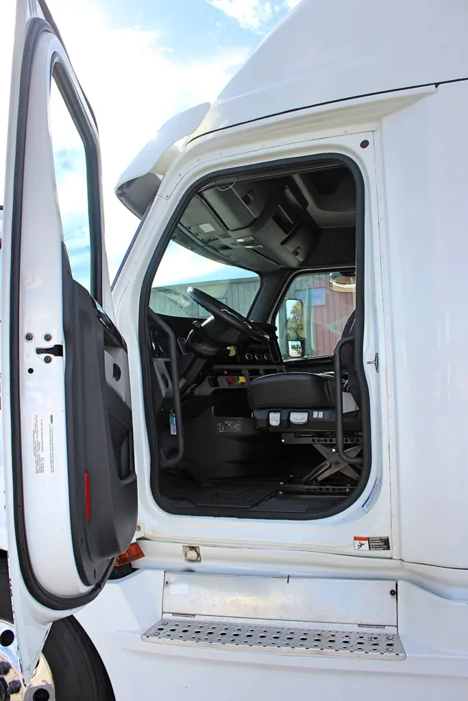 2019 Freightliner Cascadia 126 – open driver door showing cab entry and interior.