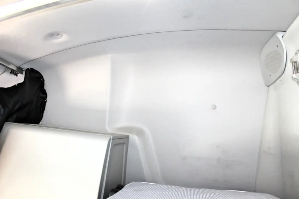 2019 Freightliner Cascadia 126 – sleeper interior upper bunk area, storage and rear cab wall.