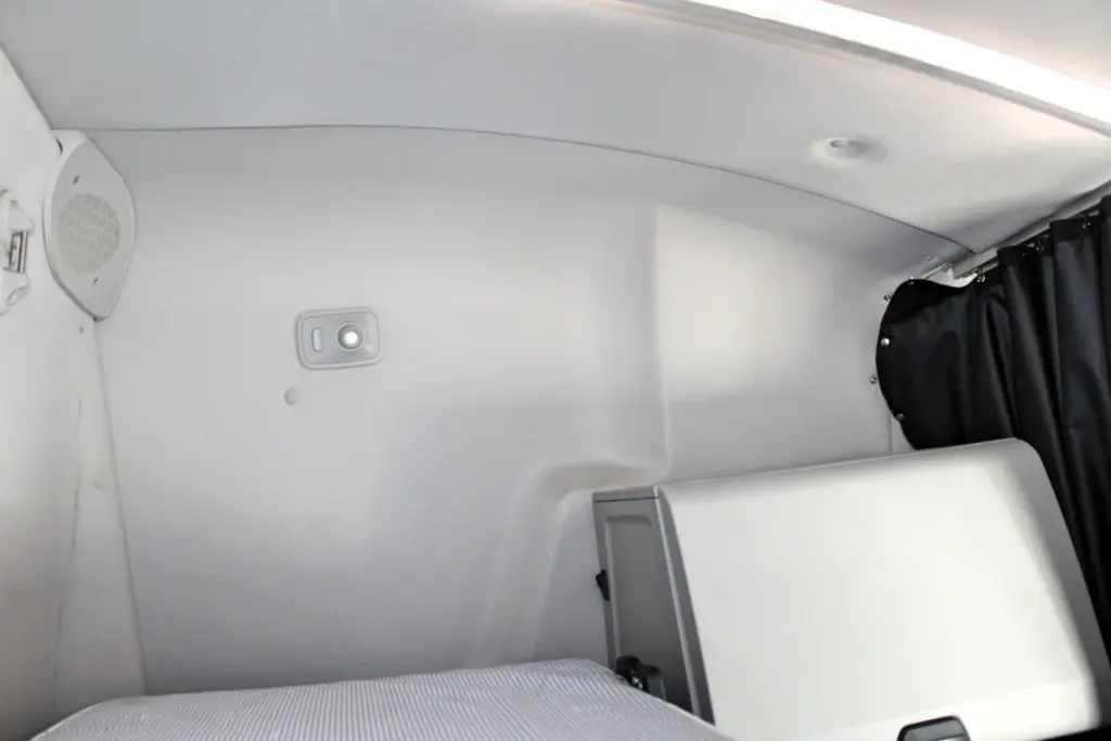 2019 Freightliner Cascadia 126 – sleeper bunk area with rear wall, curtain and storage compartment.