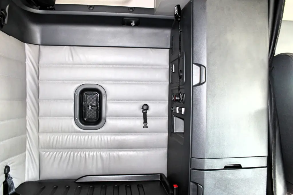2019 Freightliner Cascadia 126 – sleeper interior with lower bunk and passenger-side storage cabinet.