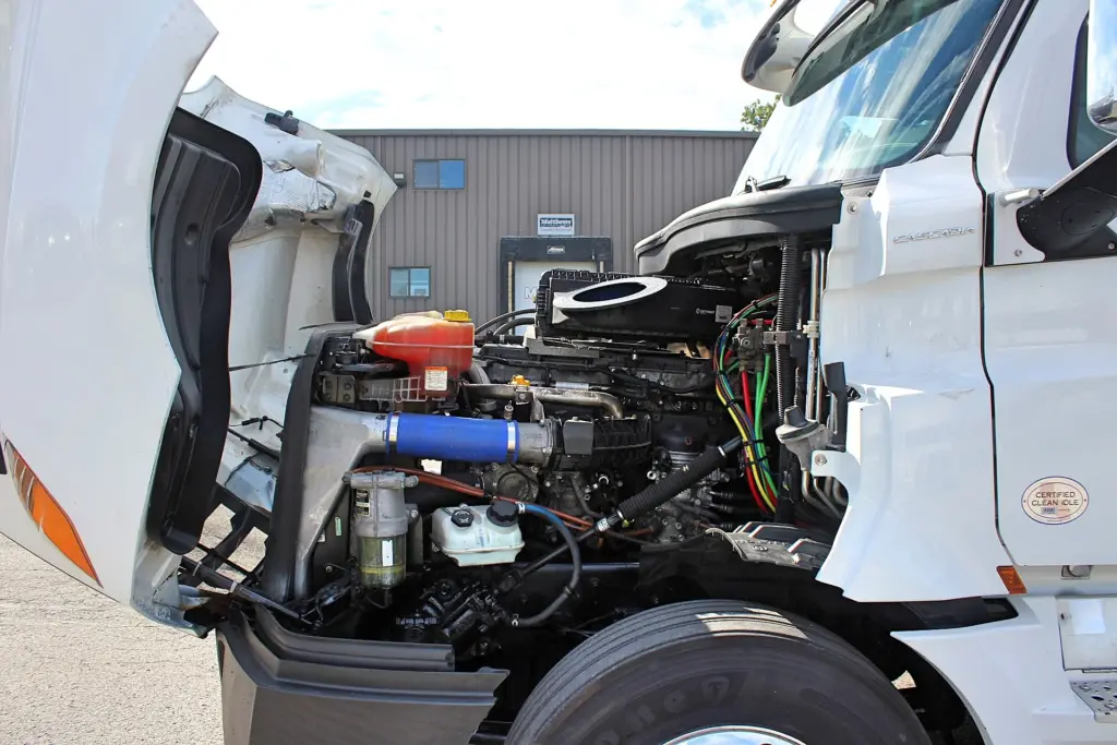 2019 Freightliner Cascadia 126 – engine compartment with hood open showing engine and cooling system.