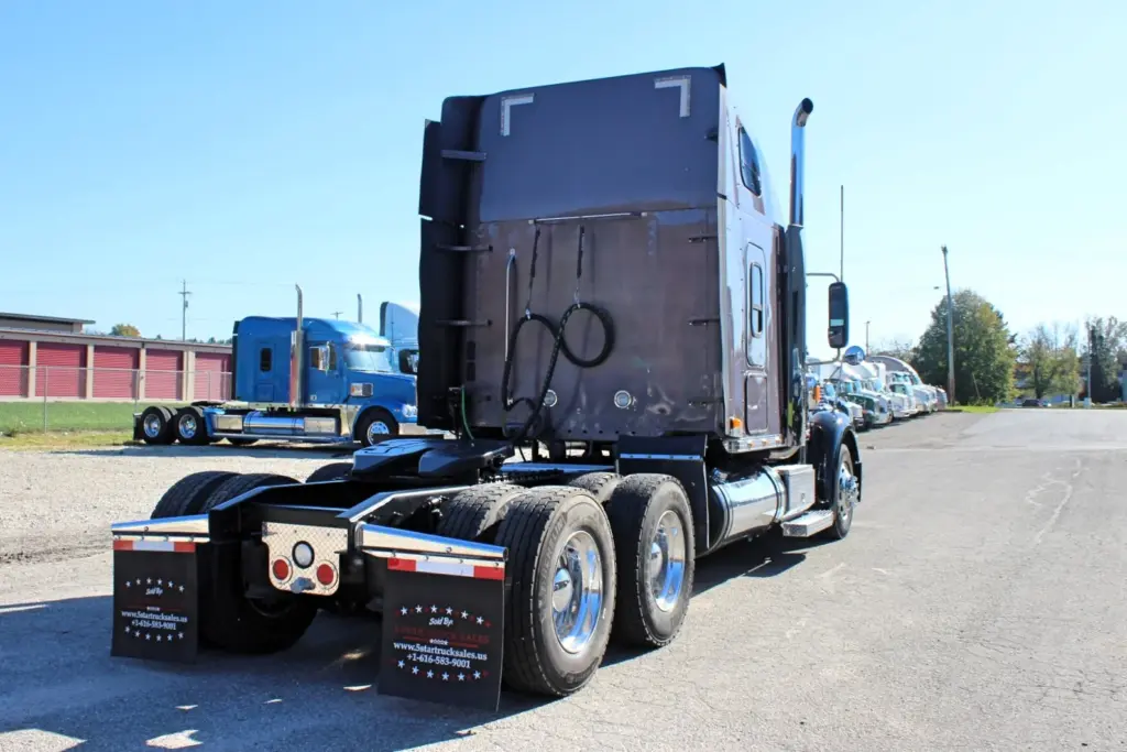 2020 Freightliner Coronado 132 — rear angle showing dual aluminum wheels on tandem axles and dark sleeper roof fairing