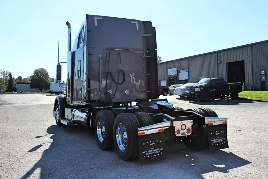 2020 Freightliner Coronado 132 — offset view of gray sleeper with polished aluminum wheels on tandem axles