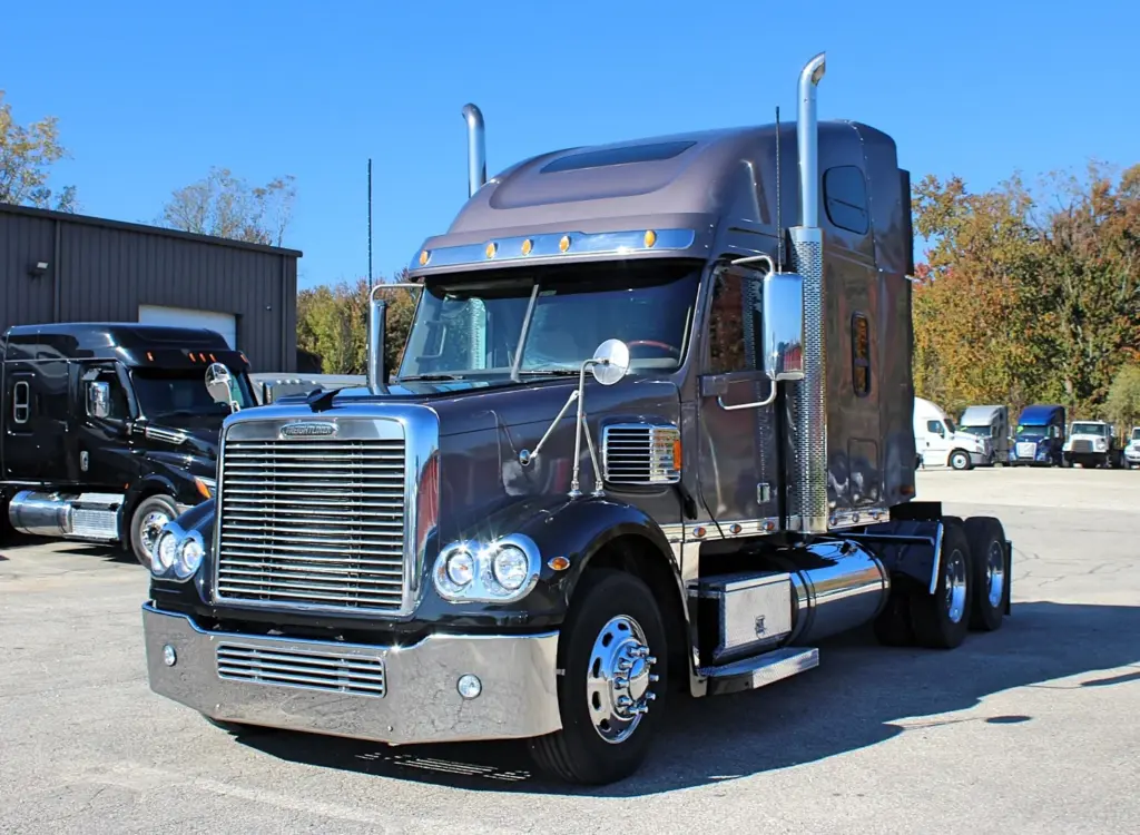 2020 Freightliner Coronado 132 — angled front view of graphite sleeper with chrome grille and bumper guard