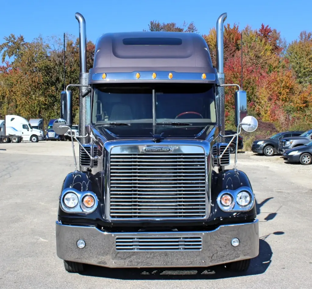 2020 Freightliner Coronado 132 — head-on front view of black sleeper with twin chrome stacks and chrome grille