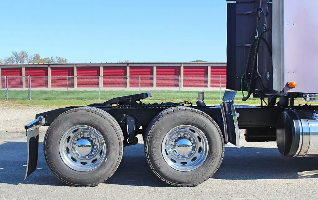 2020 Freightliner Coronado 132 — side view of tandem rear axles with polished aluminum wheels and dual tires