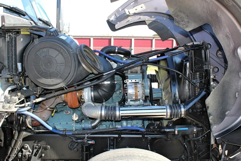 2020 Freightliner Coronado 132 — engine bay with open hood, air cleaner canister and polished intake pipe on 12.7L Detroit