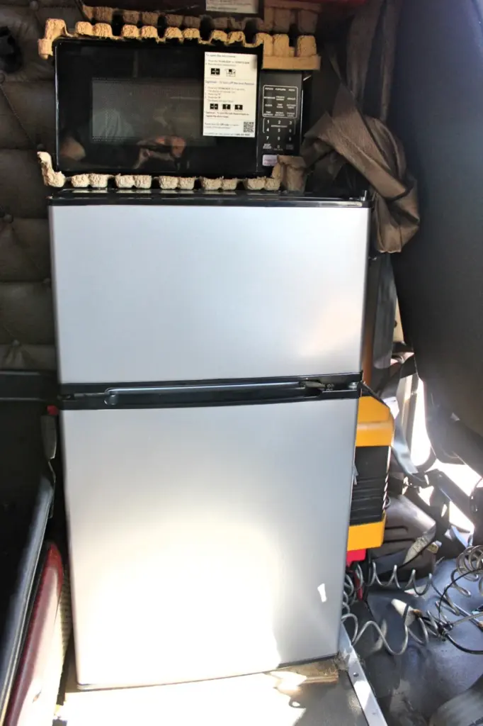 2020 Freightliner Coronado 132 — front view of a silver two-door mini fridge with microwave on top in the sleeper