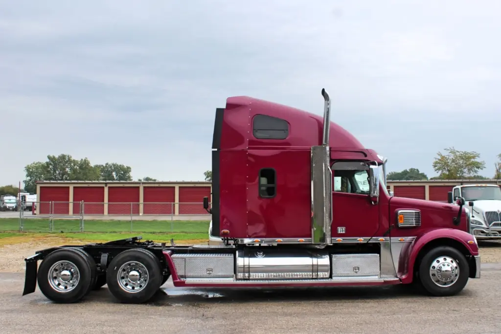 2020 Freightliner Coronado 132 Glider – passenger side profile of burgundy sleeper semi truck