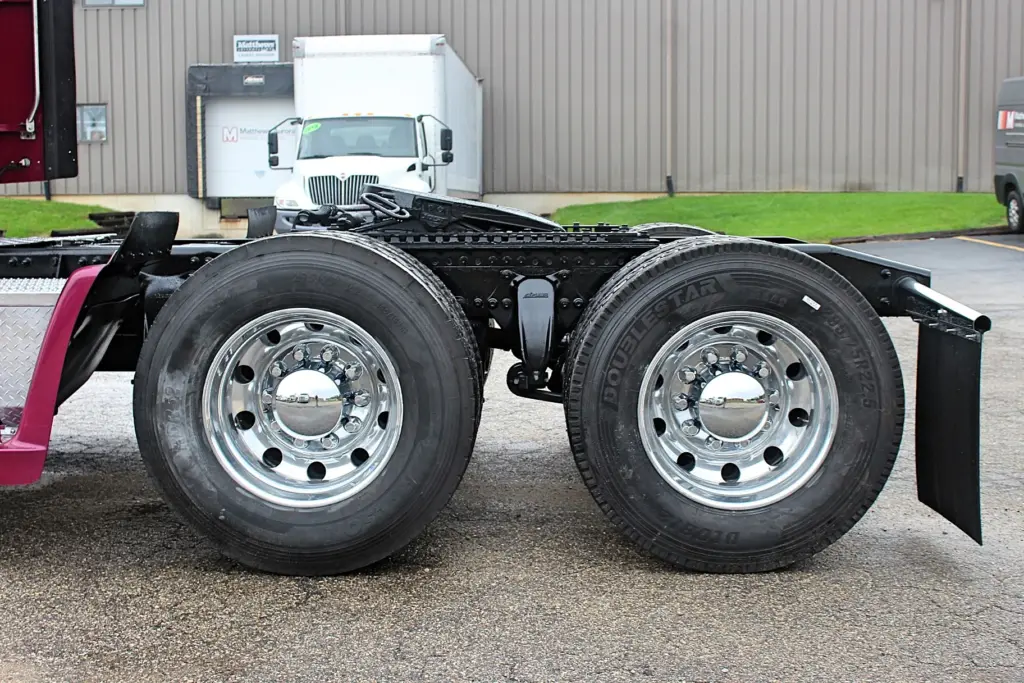 2020 Freightliner Coronado 132 Glider – tandem rear axles and polished aluminum wheels close-up