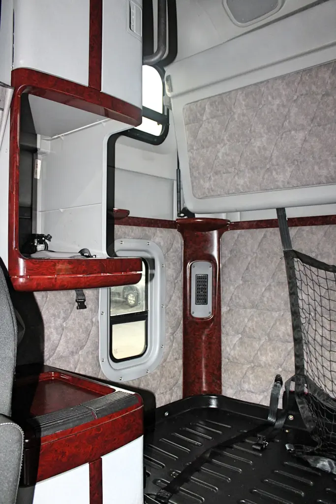 2020 Freightliner Coronado 132 Glider – sleeper interior with upper bunk, cabinetry and wood-grain trim