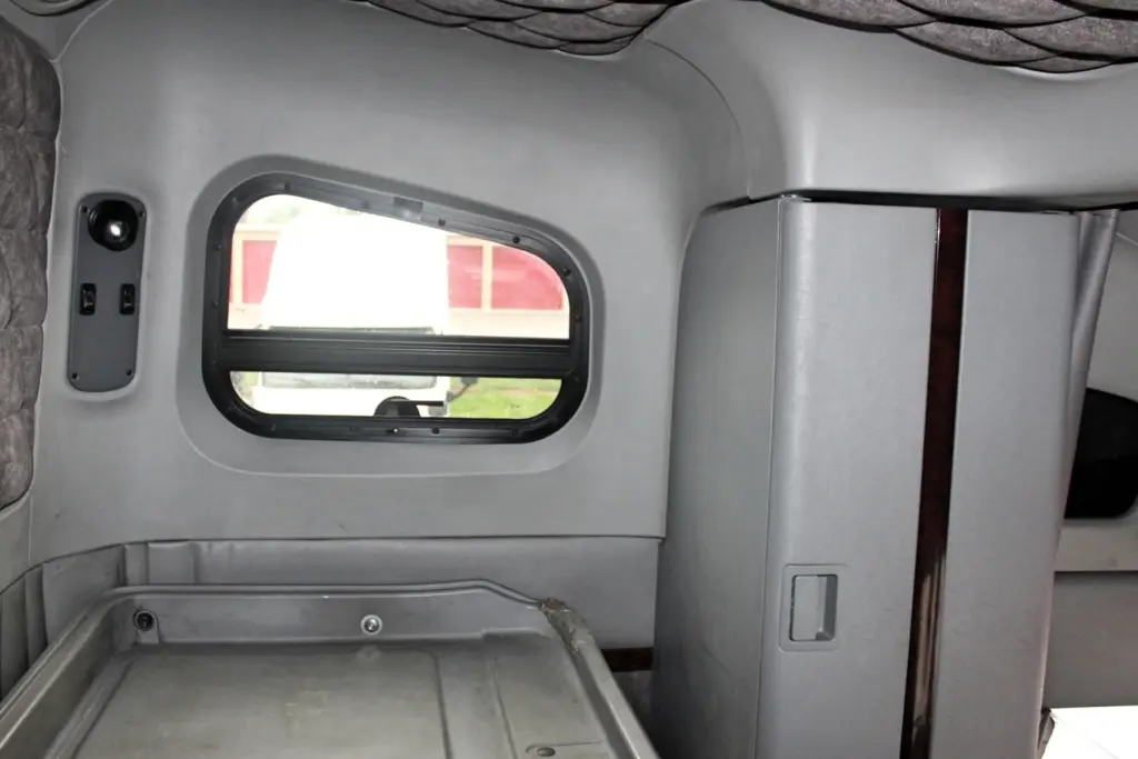 2020 Freightliner Coronado 132 Glider – sleeper interior side window, storage cabinet and padded trim