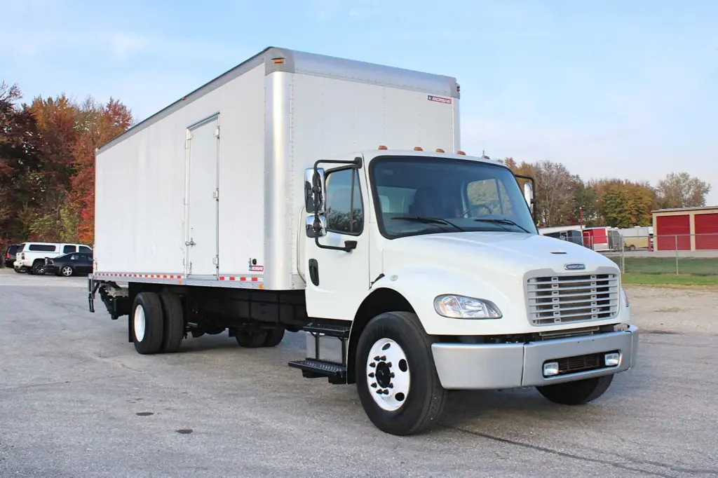 2020 Freightliner M2 106 — front three-quarter view of white box truck with aluminum steer wheels and a side service door