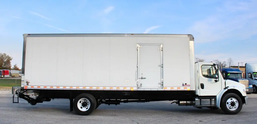 2020 Freightliner M2 106 — side profile view of white box truck with rear liftgate and mid-body side door