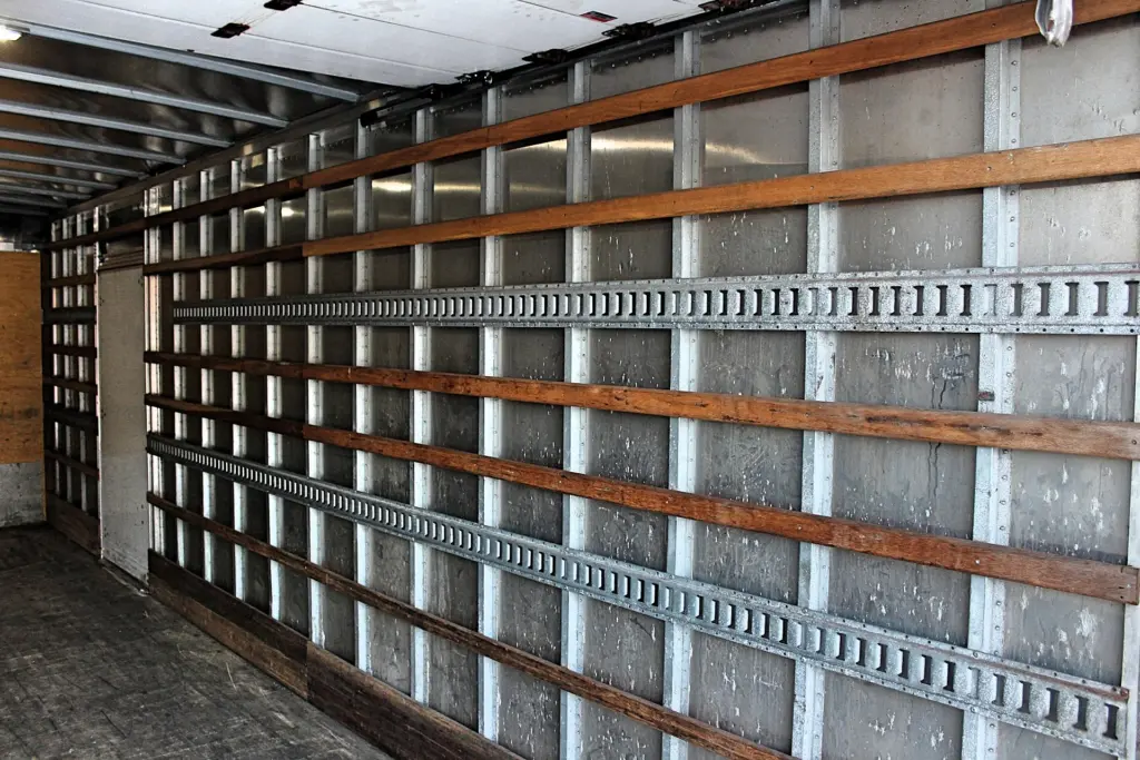 2020 Freightliner M2 106 — interior side wall of empty box, wood rails and galvanized tie rails running along the panels