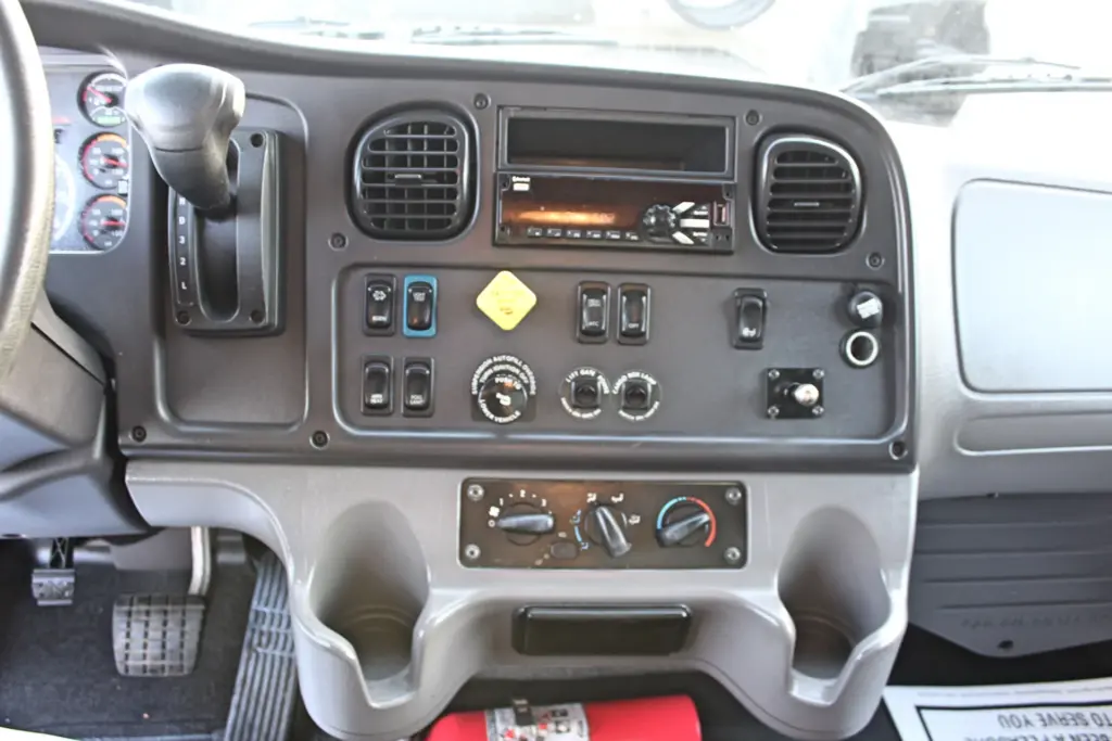 2020 Freightliner M2 106 — straight-on view of dash with Allison automatic shifter, radio head unit, rocker switches and vents