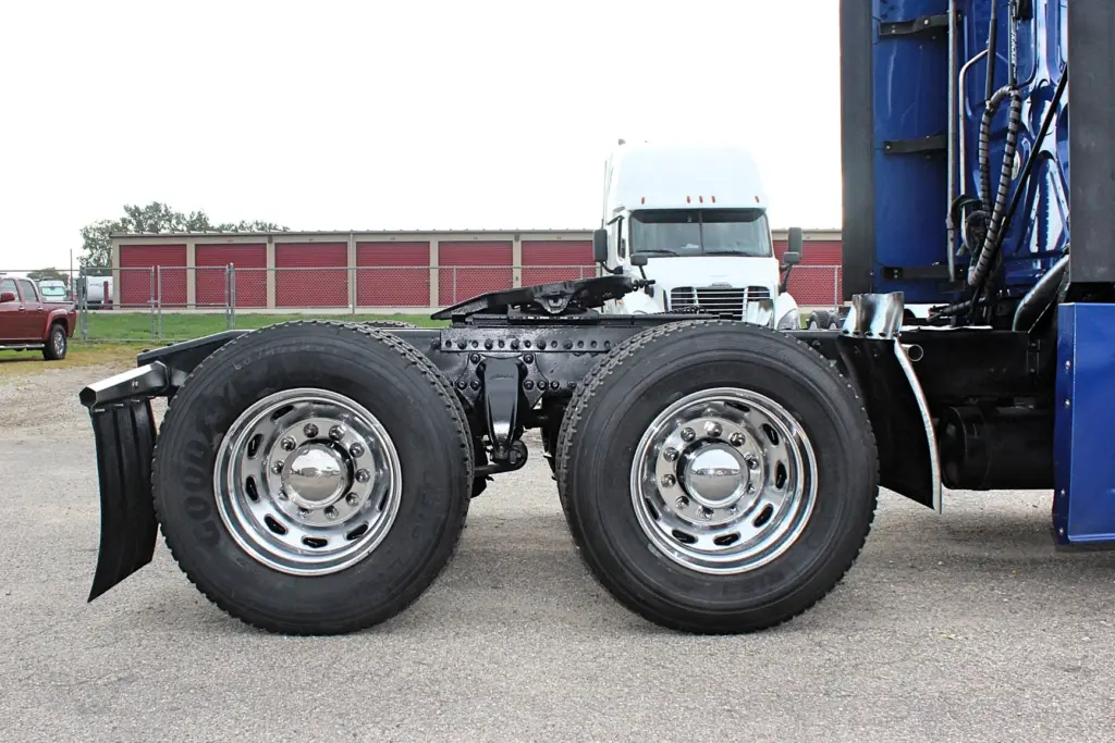 2020 Freightliner Cascadia 125 Glider – tandem rear axles and polished aluminum drive wheels close-up.