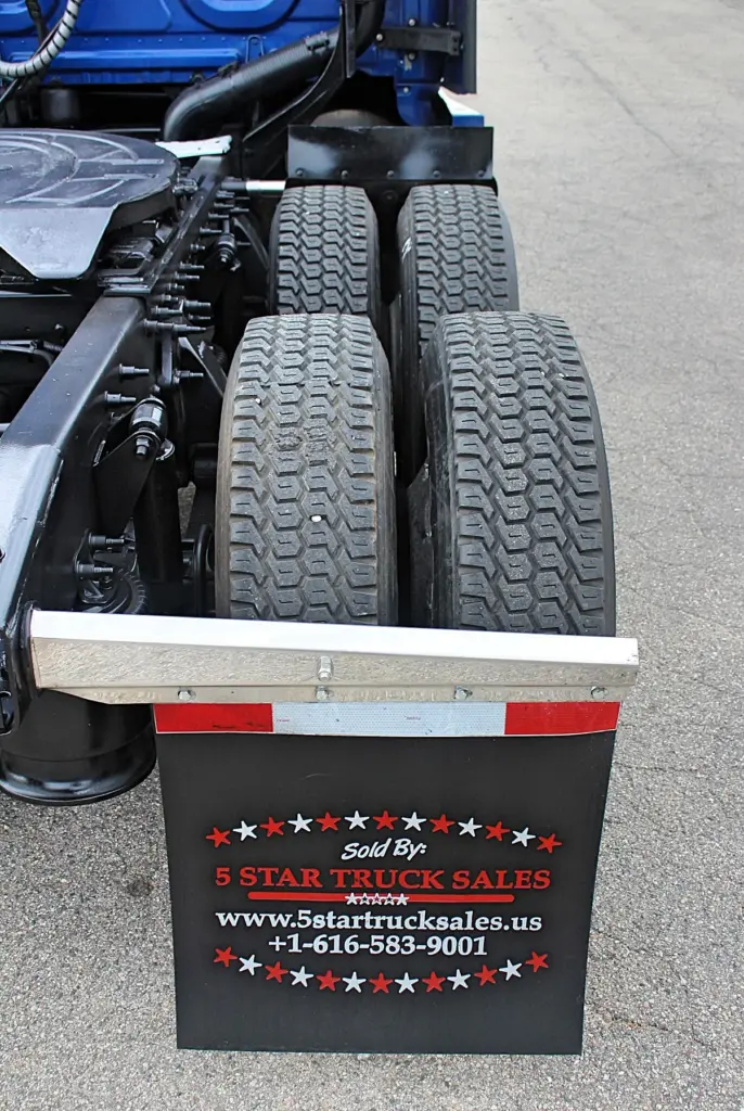 2020 Freightliner Cascadia 125 Glider – rear drive tire tread and 5 Star Truck Sales mudflap close-up.