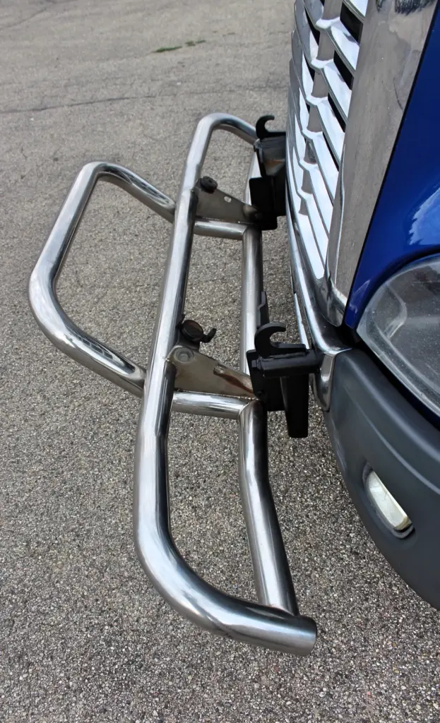 2020 Freightliner Cascadia 125 Glider – stainless steel front grille guard mounting hardware close-up.