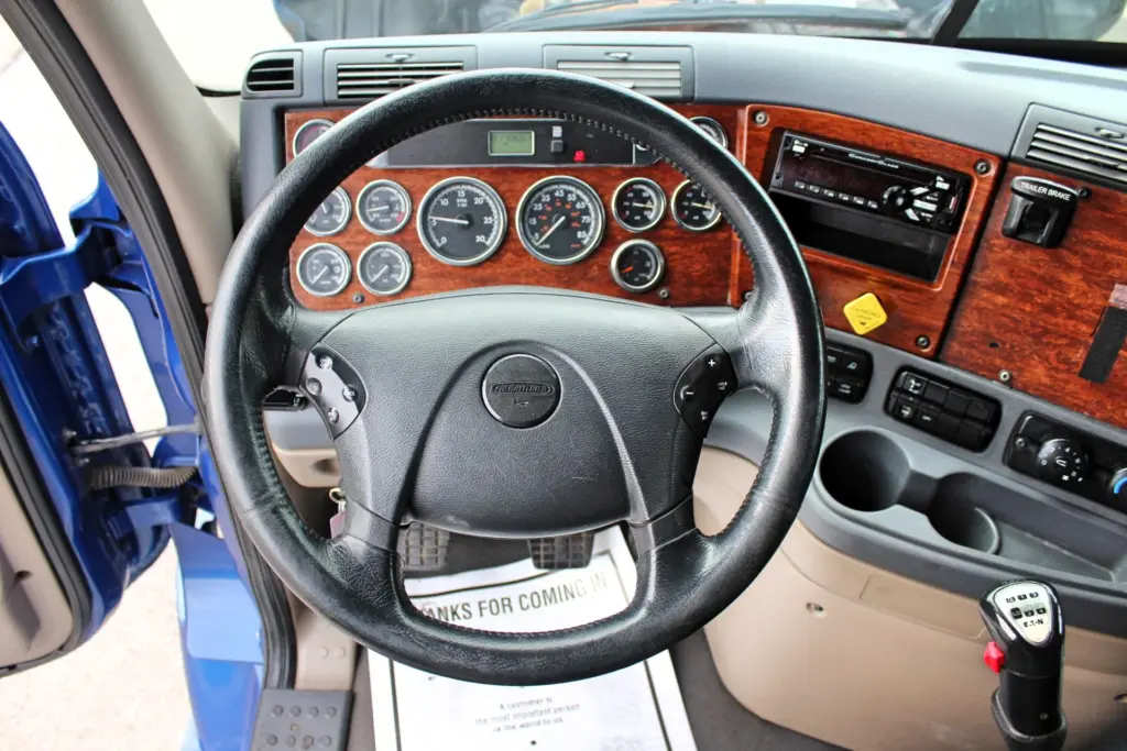 2020 Freightliner Cascadia 125 Glider – Freightliner steering wheel and woodgrain instrument panel interior.