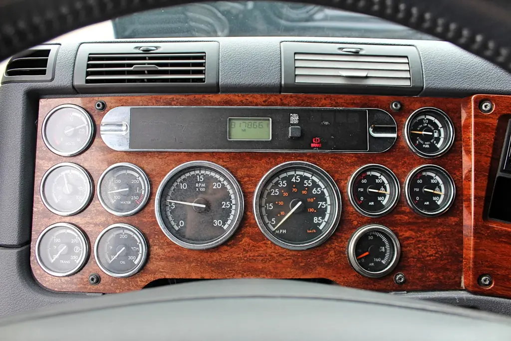2020 Freightliner Cascadia 125 Glider – woodgrain gauge cluster with tachometer, speedometer and air pressure gauges.