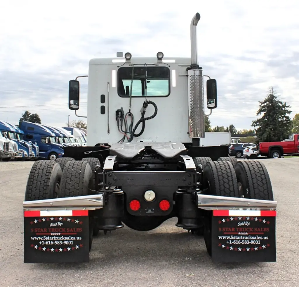 2020 Freightliner Columbia 120 — rear view of white day cab with dual rear tires and chrome stack.
