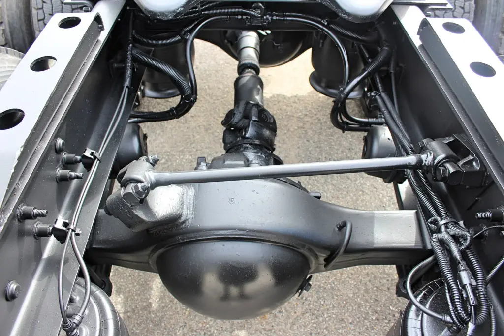 2020 Freightliner Columbia 120 — underside view of rear drive axle with driveshaft, torque rod and black air lines.