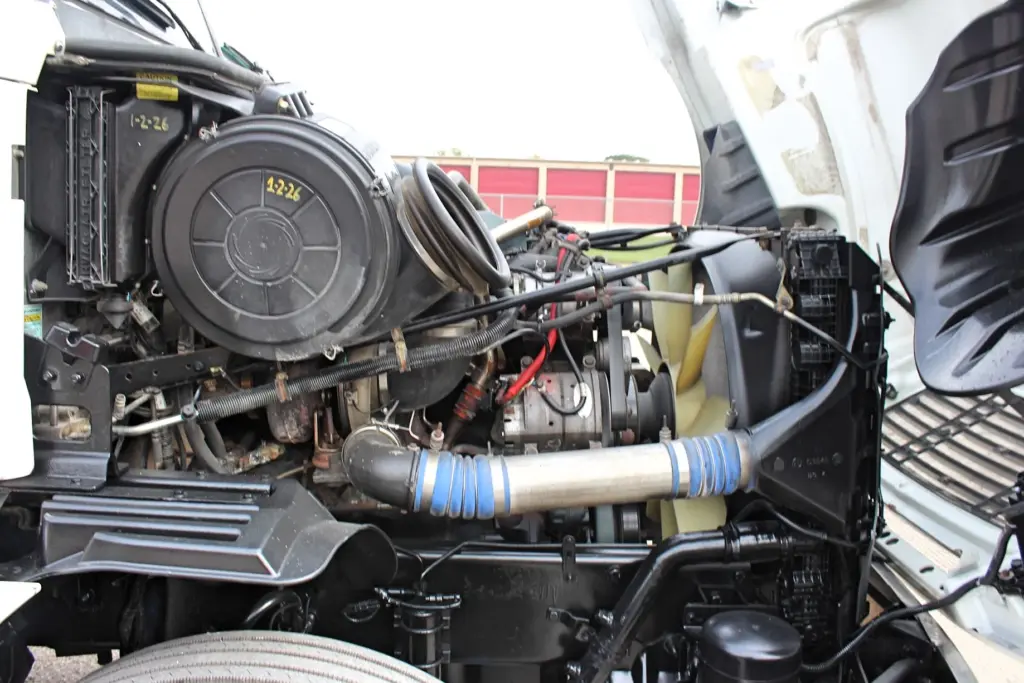 2020 Freightliner Columbia 120 — open hood showing Detroit Series 60 with blue charge air tube and black air cleaner.
