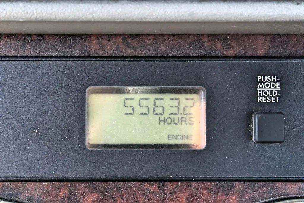 2020 Freightliner Columbia 120 — close view of engine hour meter showing 5563.2 hours on a dark dash panel.