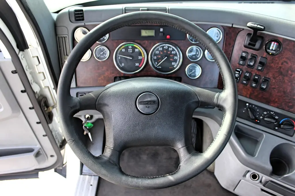 2020 Freightliner Columbia 120 Glider – clean day cab interior with driver seat and dashboard