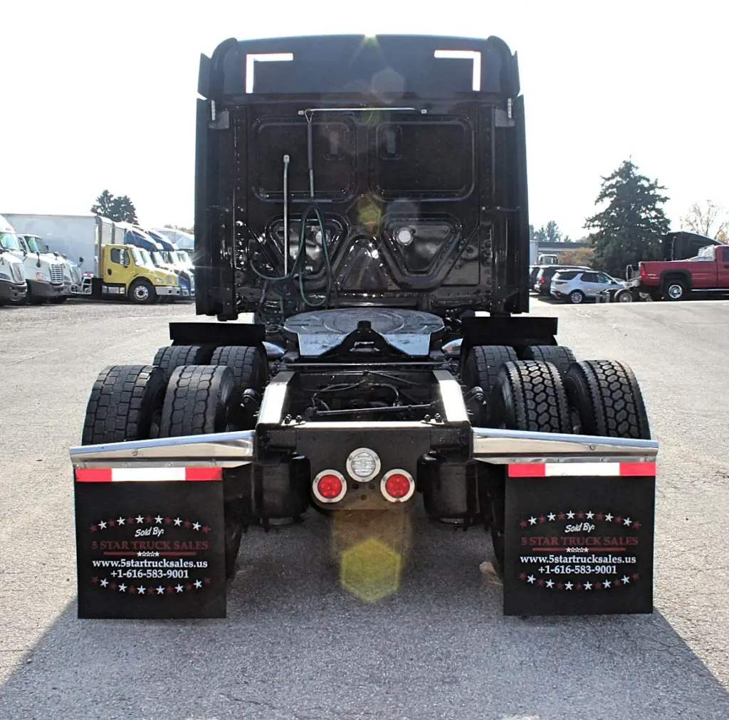 2021 Freightliner Cascadia 126 — straight-on rear view of black sleeper with centered tail lights and dual tires