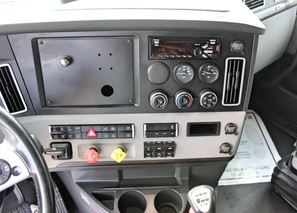 2021 Freightliner Cascadia 126 — dash center panel with radio, air and oil gauges, climate knobs and Eaton shifter